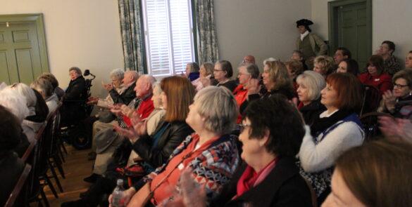 People seated in the Meeting House